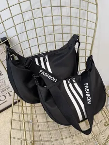 Black Oxford cloth dumpling shoulder bag detail featuring stylish striped strap design.
