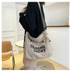 Casual beige canvas shoulder crossbody bag with stylish letter print for spacious daily use.