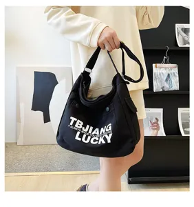 Black canvas tote bag for women, large capacity shoulder crossbody bag with letter print.