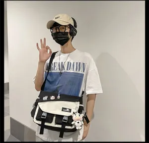 Detail shot of men's casual colorblock messenger bag, stylish streetwear canvas crossbody bag.