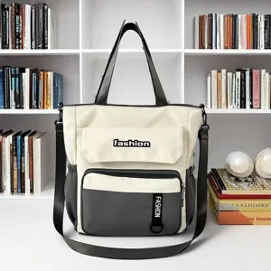 Detailed view of the large capacity canvas shoulder crossbody bag with front pocket design.