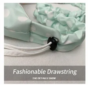 Detailed view of the mint green polka dot canvas tote bag featuring adjustable drawstring.