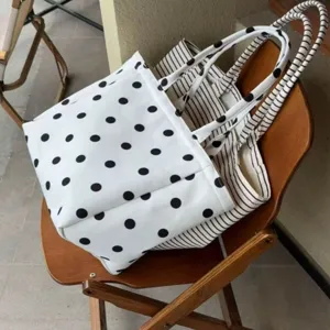 White polka dot women's tote bag, casual commuting large capacity shoulder bag style.