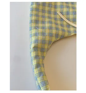 Japanese fresh style yellow and blue plaid canvas handbag detail shot, casual tote bag design.
