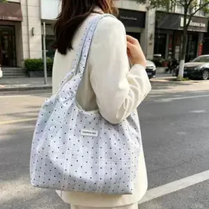 Canvas shoulder tote bag featuring stylish polka dot and plaid pattern for casual daily use.