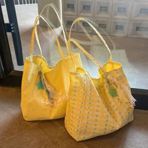 Yellow canvas tote bag detail, double-sided wave pattern and polka dot lining, large capacity.