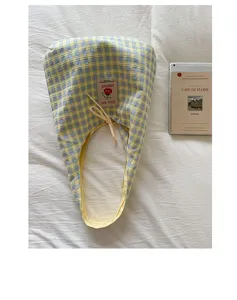 Detailed view of the Japanese style yellow blue plaid canvas tote bag with cute tomato label and bow.