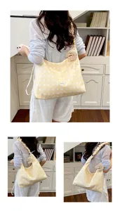 Detailed view of yellow polka dot canvas hobo shoulder bag with cute bear pendant, large capacity.