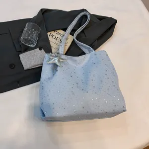 Details of the light blue star print tote bag with starfish pendant, casual daily style.