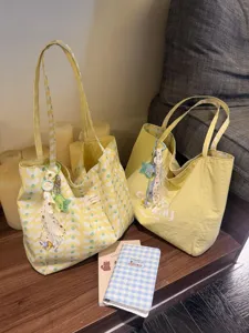 Large capacity canvas tote bag with stylish wavy dot pattern and casual commuter design details.