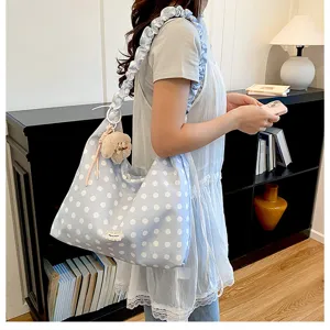 Korean style blue polka dot canvas shoulder bag with ruffled strap, large capacity tote bag detail.