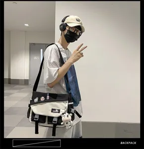 Men canvas messenger bag, Japanese style color block casual crossbody bag with cute pendant.