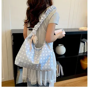 Detailed view of the cute blue polka dot canvas tote bag with ruffled strap for daily commute.