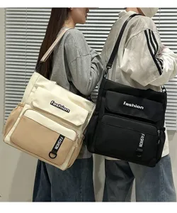 Detailed view of large capacity canvas messenger bag with multiple pockets and shoulder strap.