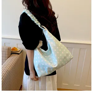 Detailed view of the Korean style polka dot canvas shoulder bag with unique ruffled strap.
