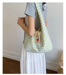 Detail shot of Japanese style plaid canvas tote bag with cute tomato label and bow.