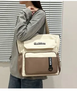 Large capacity color block canvas tote bag, detailed view of front pockets and fashion text.