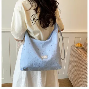 Detailed view of the sweet large capacity tote bag featuring cute star prints and strap.