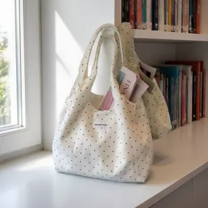 White canvas tote bag featuring black polka dots, stylish casual shoulder bag for daily use.