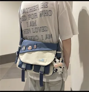 Canvas crossbody messenger bag for men and women, stylish color block casual bag.