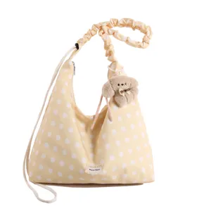 Korean style polka dot canvas shoulder bag with cute plush dog pendant and hobo design.