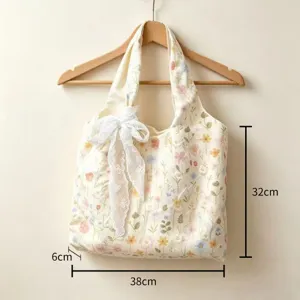 Detailed view of canvas floral embroidered tote bag with lace bow, dimensions 38x32x6cm.
