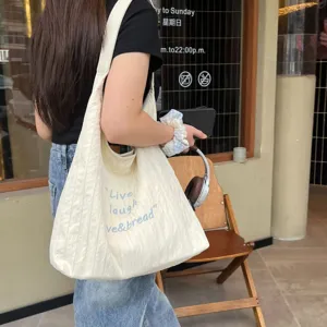 Casual pleated canvas shoulder bag for women, large capacity stylish tote bag for daily commute.