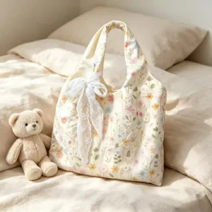 Floral embroidered canvas tote bag with delicate white lace bow detail for daily casual use.