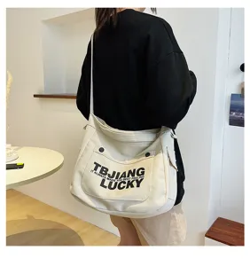Large capacity canvas shoulder bag casual crossbody tote for women student daily commuting.