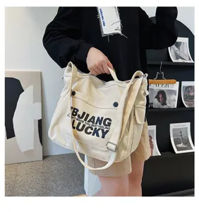 Large capacity canvas shoulder bag, Korean style casual student tote bag with letter print detail.
