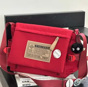 Red canvas messenger bag large capacity casual vintage crossbody bag for students daily commuting style.
