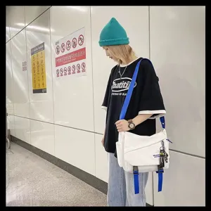 Casual white canvas messenger bag with blue straps, stylish daily crossbody bag for students.