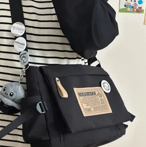 Casual large-capacity black canvas messenger bag, Japanese retro crossbody commuter bag detail.