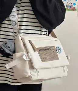 Canvas messenger bag detail showing casual retro style, adjustable strap and pockets.