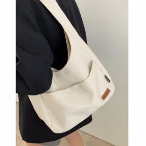 Casual canvas shoulder bag for women, stylish daily crossbody bag with wide strap.