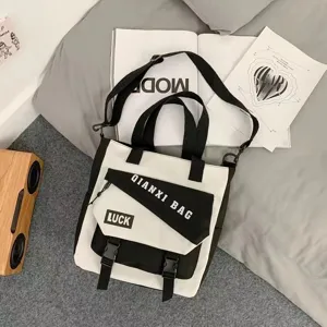 Canvas crossbody shoulder bag with large capacity, black and white stylish tote for daily use.