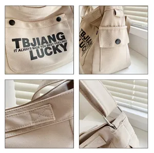 Close up detail of casual canvas tote bag with front pocket, metal hardware and neat stitching.