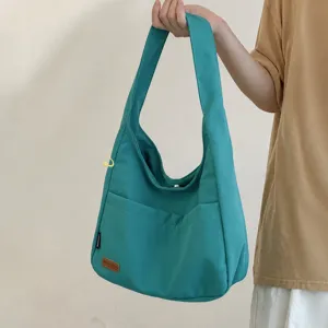 Casual canvas shoulder bag for women, hobo style messenger bag with front pocket design.