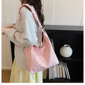 Detailed view of the pink starry print tote bag with stylish gathered shoulder strap.