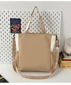 Detailed view of the stylish canvas shoulder bag in beige and white color block design.