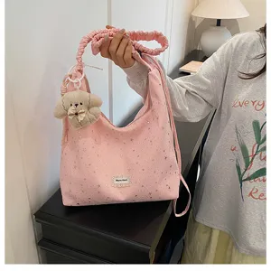 Sweet pink star print tote bag with cute puppy charm and gathered strap for daily use.