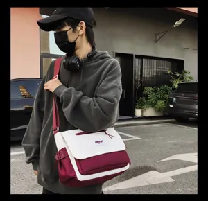 Stylish canvas messenger bag featuring a two-tone design, ideal for daily casual wear.
