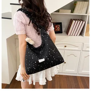 Detail view of the black starry print tote bag showcasing its large capacity and soft fabric.