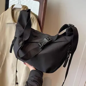 Detail shot of black nylon crossbody bag, large capacity hobo style with adjustable strap.