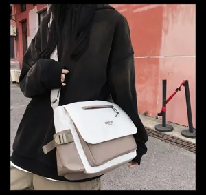 Canvas messenger bag detail showing color blocked design, large capacity and adjustable strap.