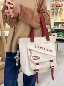 Sac à main cabas bandoulière en toile pour femme, design élégant couleur contrastée.