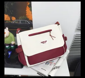 Nylon messenger bag featuring a spacious dual-tone design, front zip pocket, and stylish daily use.