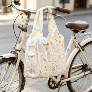 Floral embroidered canvas shoulder bag with elegant white lace bow for casual daily use.