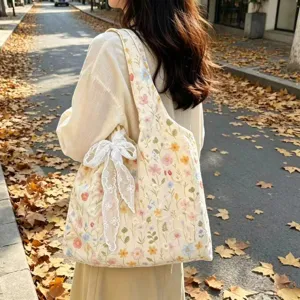Canvas tote bag with vintage floral embroidery and white lace bow for women daily use.