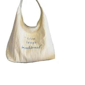 Large capacity canvas shoulder tote bag for women with chic letter embroidery and stylish hobo design.
